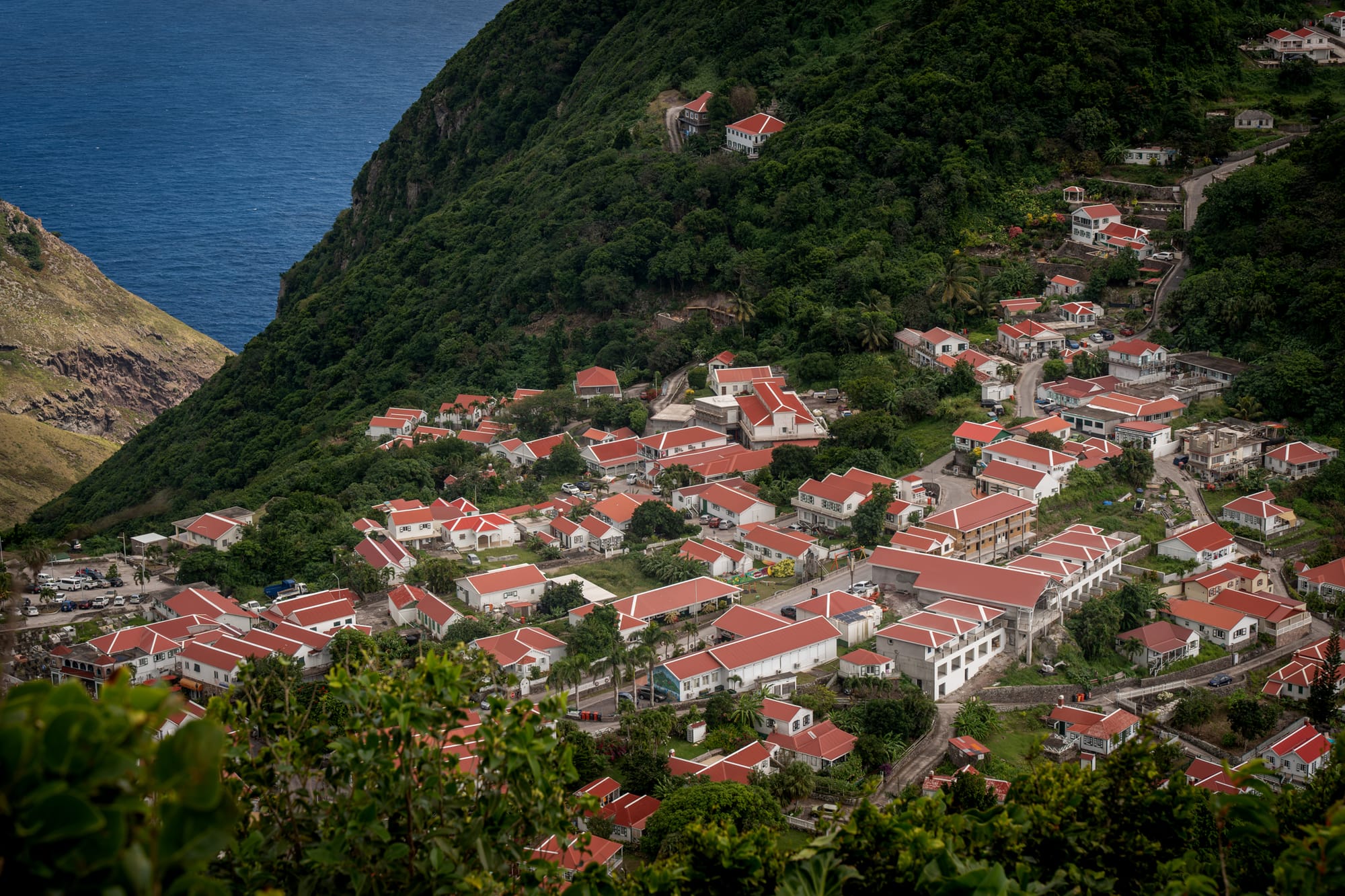 Red roofs of Windwardside against the green slope of Mount Scenery